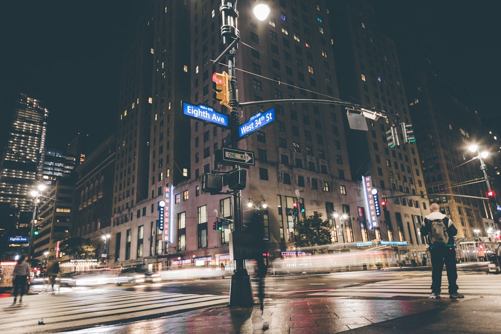 a couple of people standing on a street corner