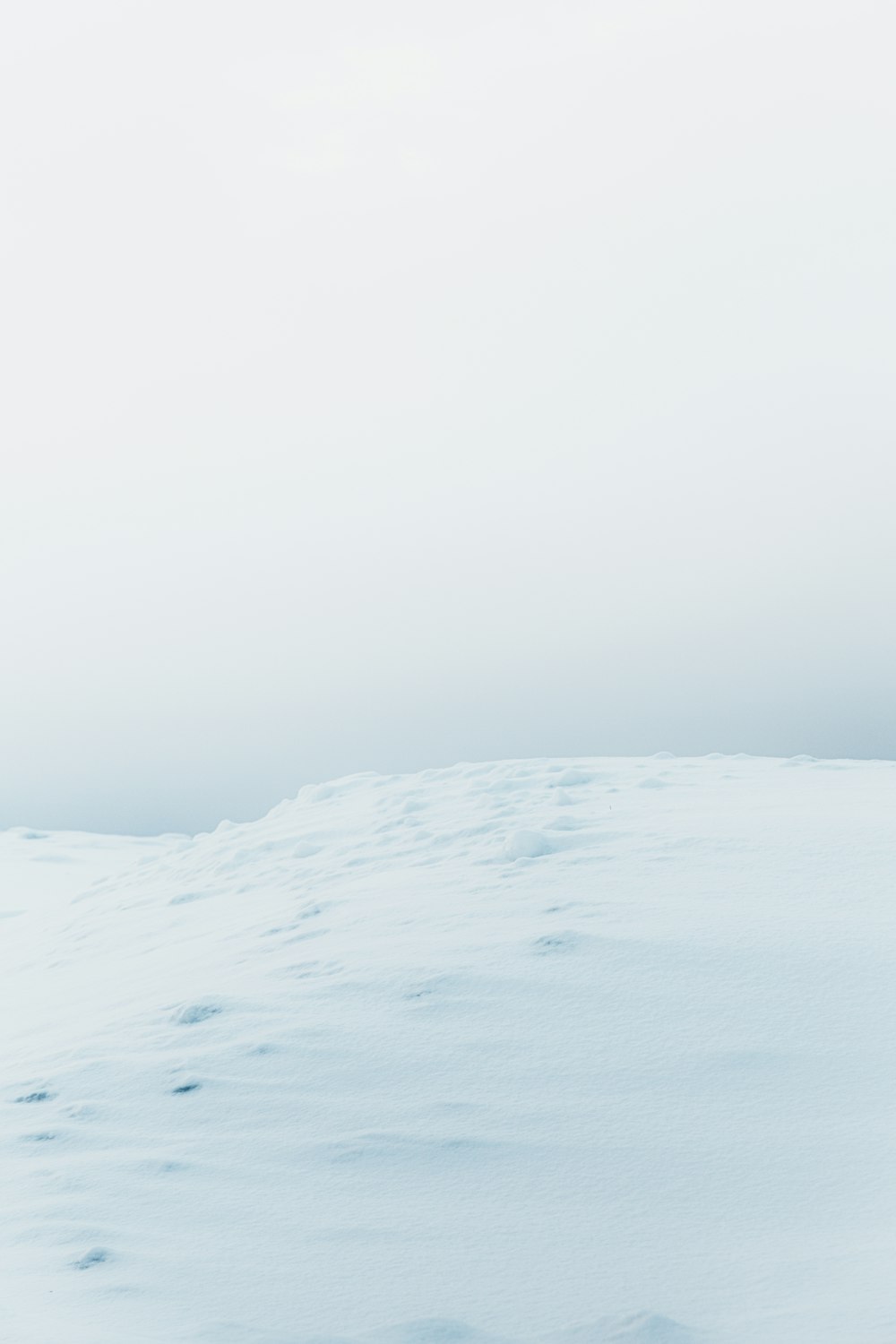 a person walking across a snow covered field