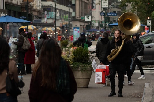 A vibrant street scene showcasing musicians playing in a bustling urban environment.