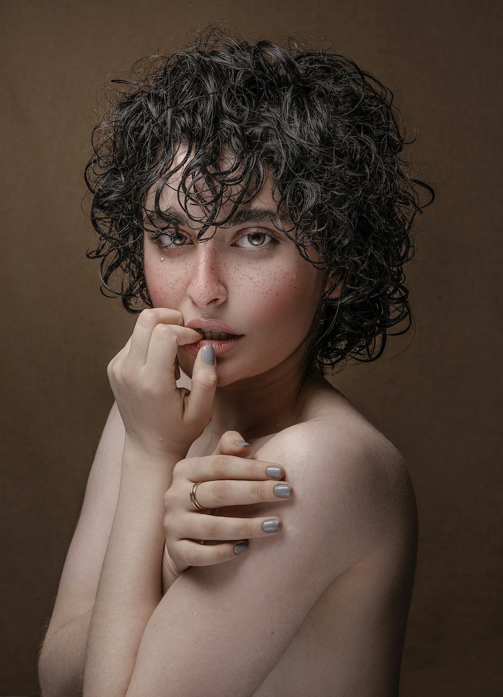 a woman with curly hair is posing for a picture