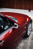 a red sports car parked in a parking lot