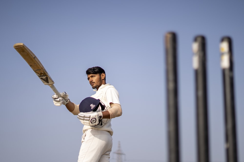 a man holding a bat and wearing a helmet