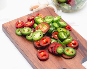 a cutting board topped with sliced bell peppers
