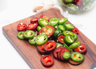 a cutting board topped with sliced bell peppers