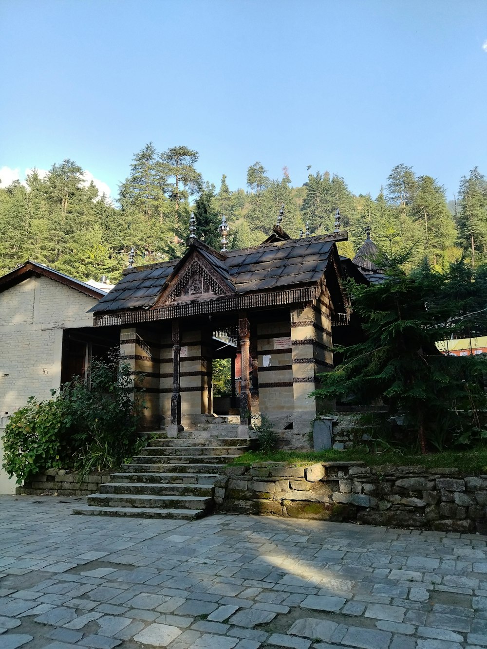 a small wooden building with steps leading up to it