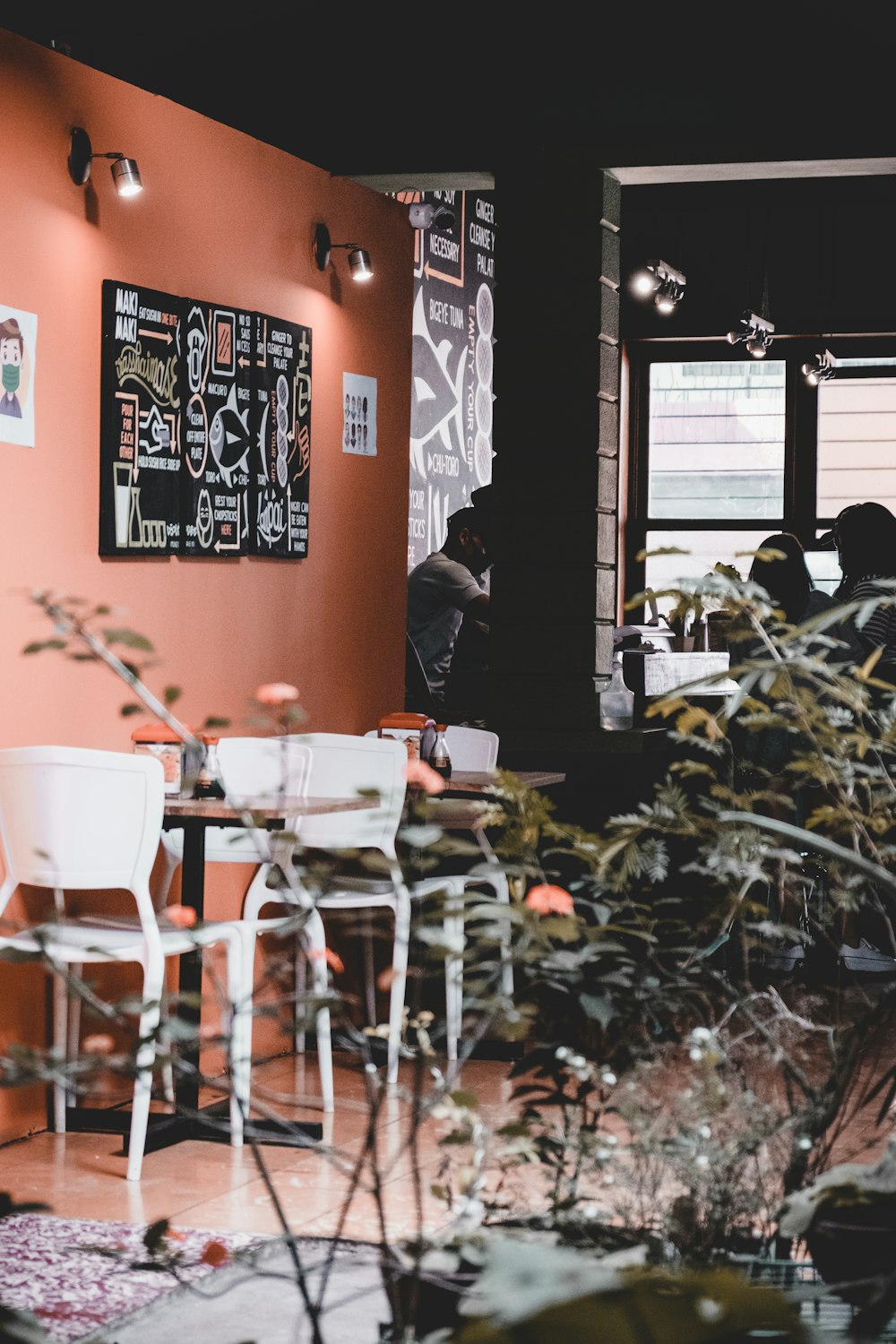 a restaurant with tables, chairs, and plants