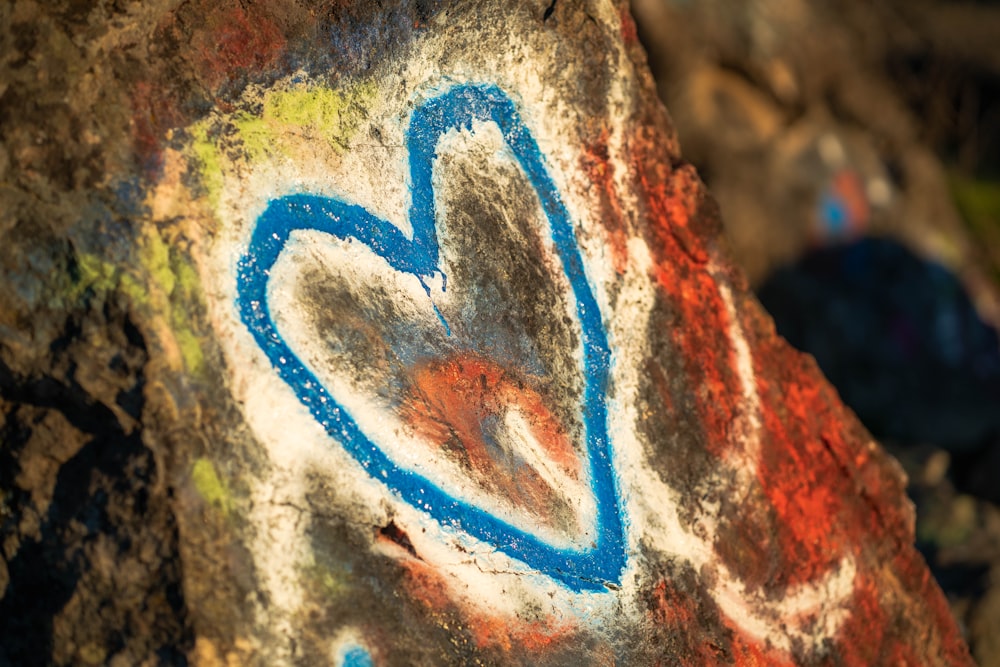 a close up of a rock with graffiti on it