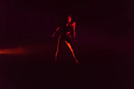 Dynamic portrait of a team member with a fiery background casting dramatic shadows.