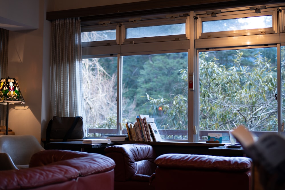 a living room filled with furniture and a large window