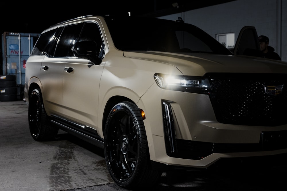 a white suv parked inside of a garage