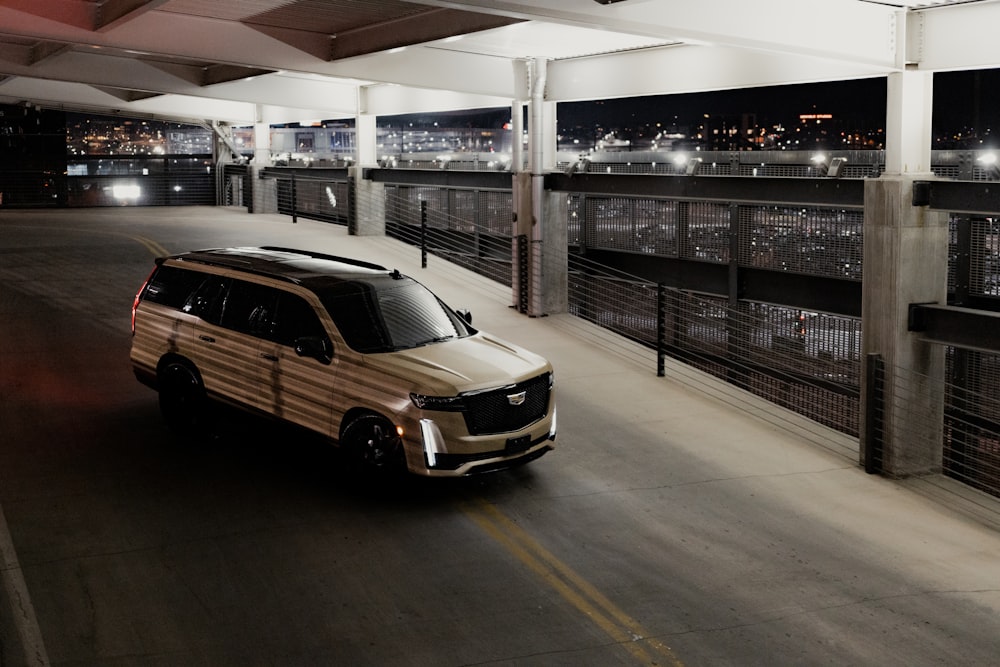 a van driving down a street next to a parking garage