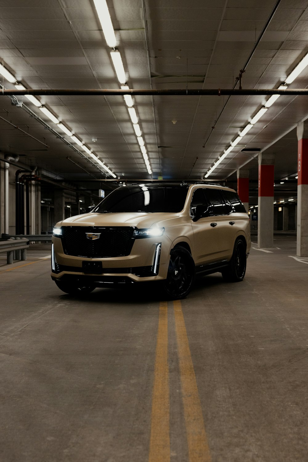 a white suv parked in a parking garage