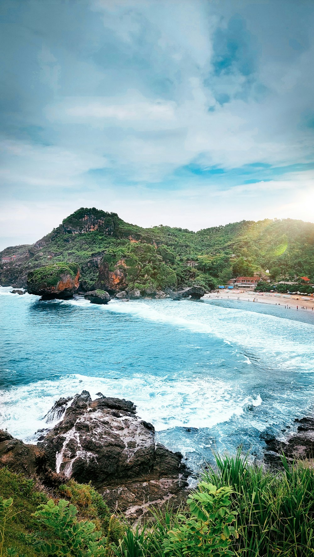 a view of a beach with a mountain in the background