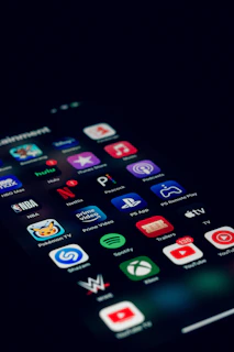 a close up of a cell phone with many different app icons