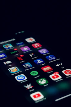 a close up of a cell phone with many different app icons