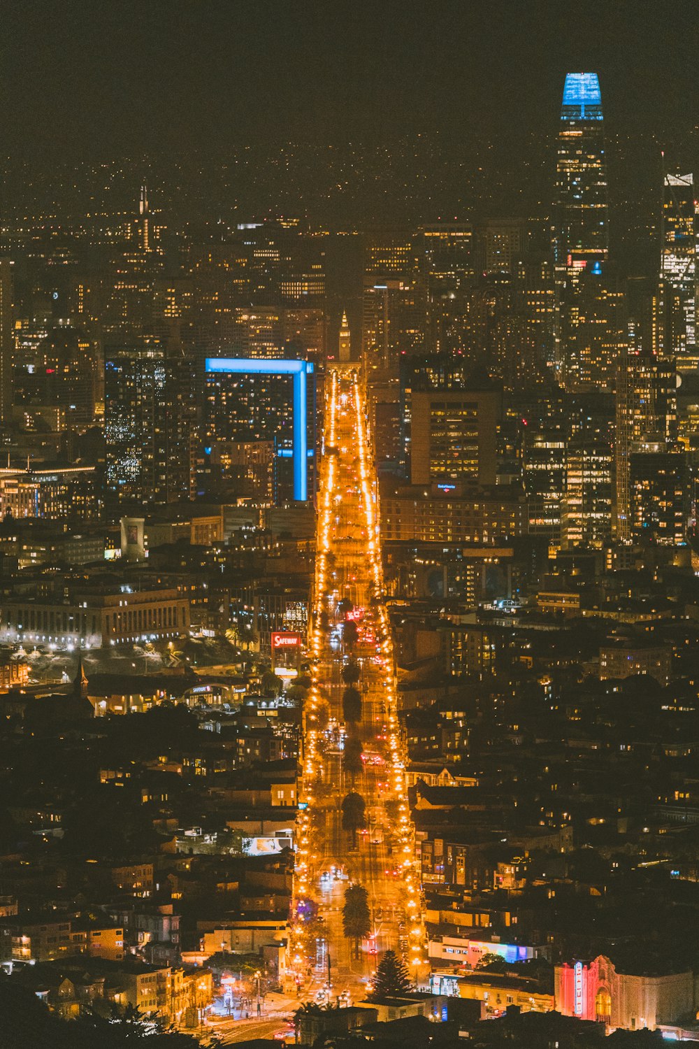 a view of a city at night from the top of a hill