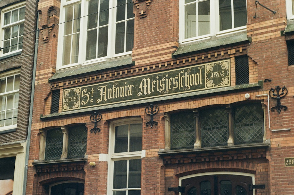a brick building with a sign on the front of it
