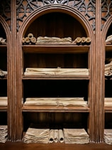 a wooden shelf filled with lots of books