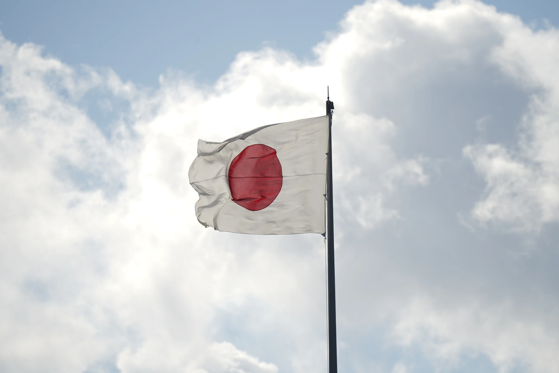 a white and red flag flying in the sky