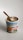 Ben & Jerry's ice cream tub labeled 'Netflix & Chilll'd Non-Dairy' is topped with light-colored ice cream. A wooden spoon is sticking out of the ice cream, suggesting it's ready to be eaten. The label shows a pretzel and a swirl of peanut butter, hinting at the flavors.