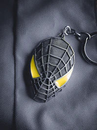 A stylish QR keychain hanging from a backpack zipper