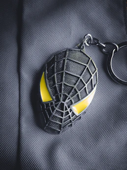 A stylish QR keychain hanging from a backpack zipper