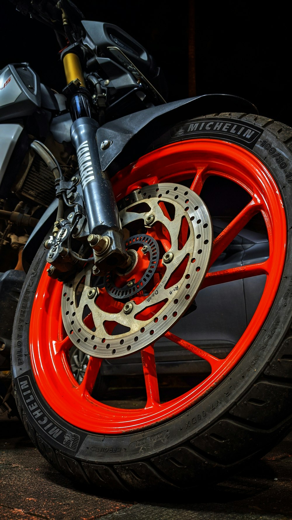a close up of a motorcycle wheel with red spokes