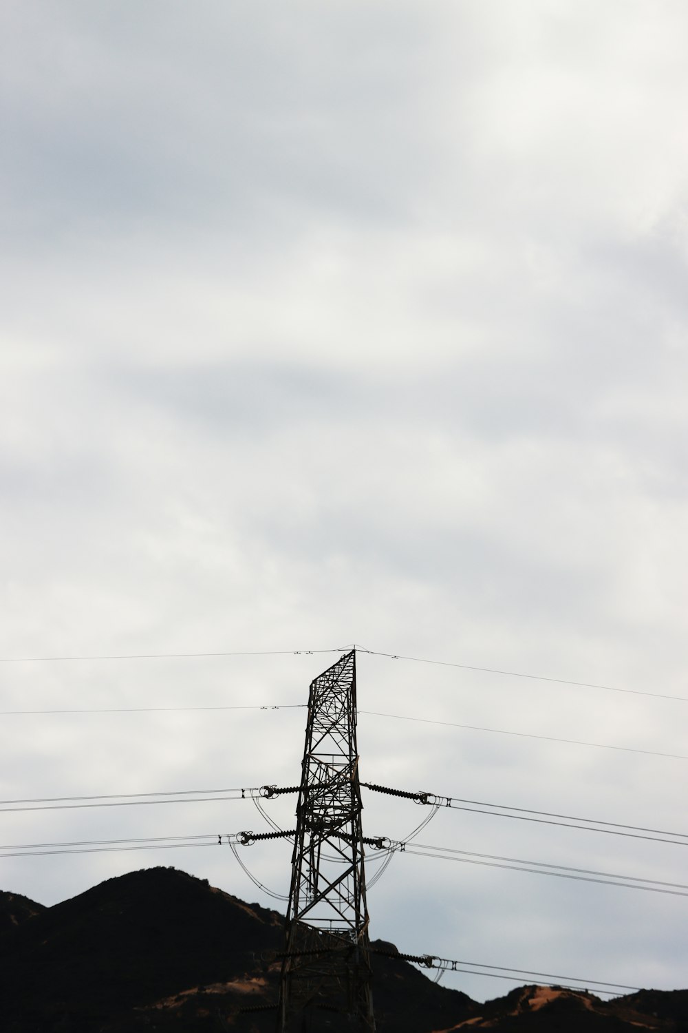 a tall metal tower sitting on top of a hill