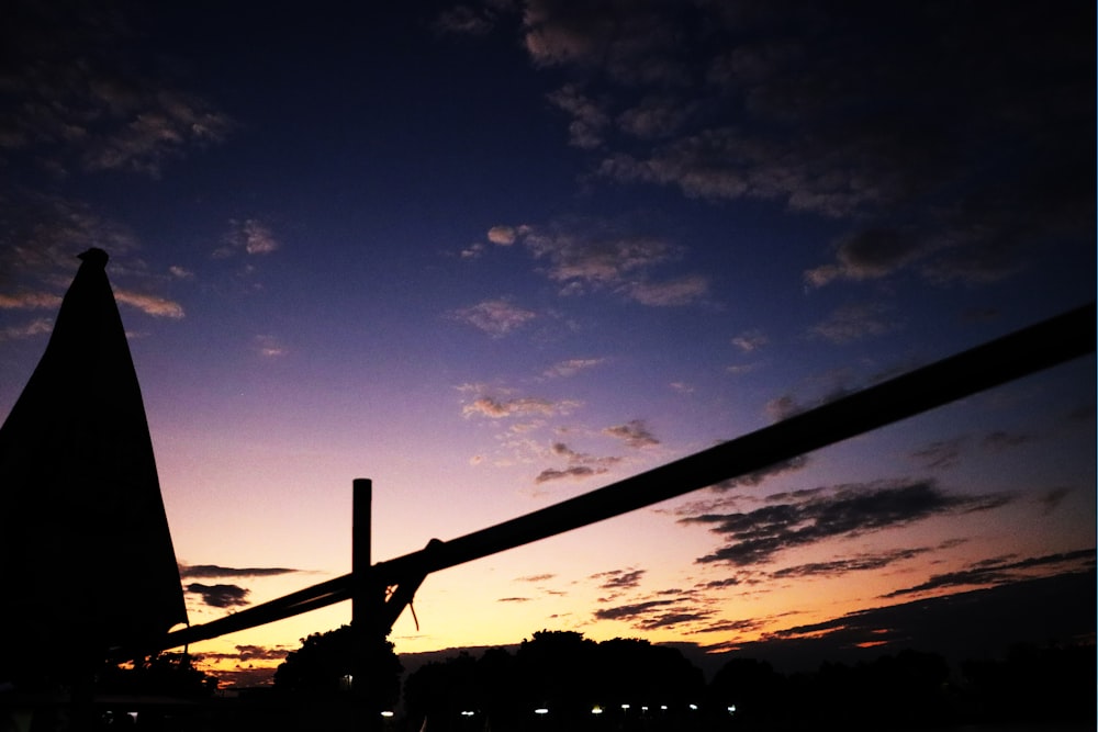 a cross is silhouetted against the evening sky