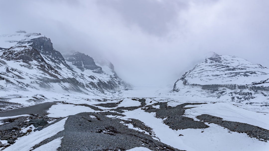 a snow covered mountain range with a cloudy sky, Spectacular Columbia Icefield