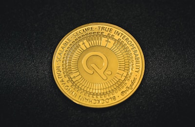 a close up of a gold coin on a black surface