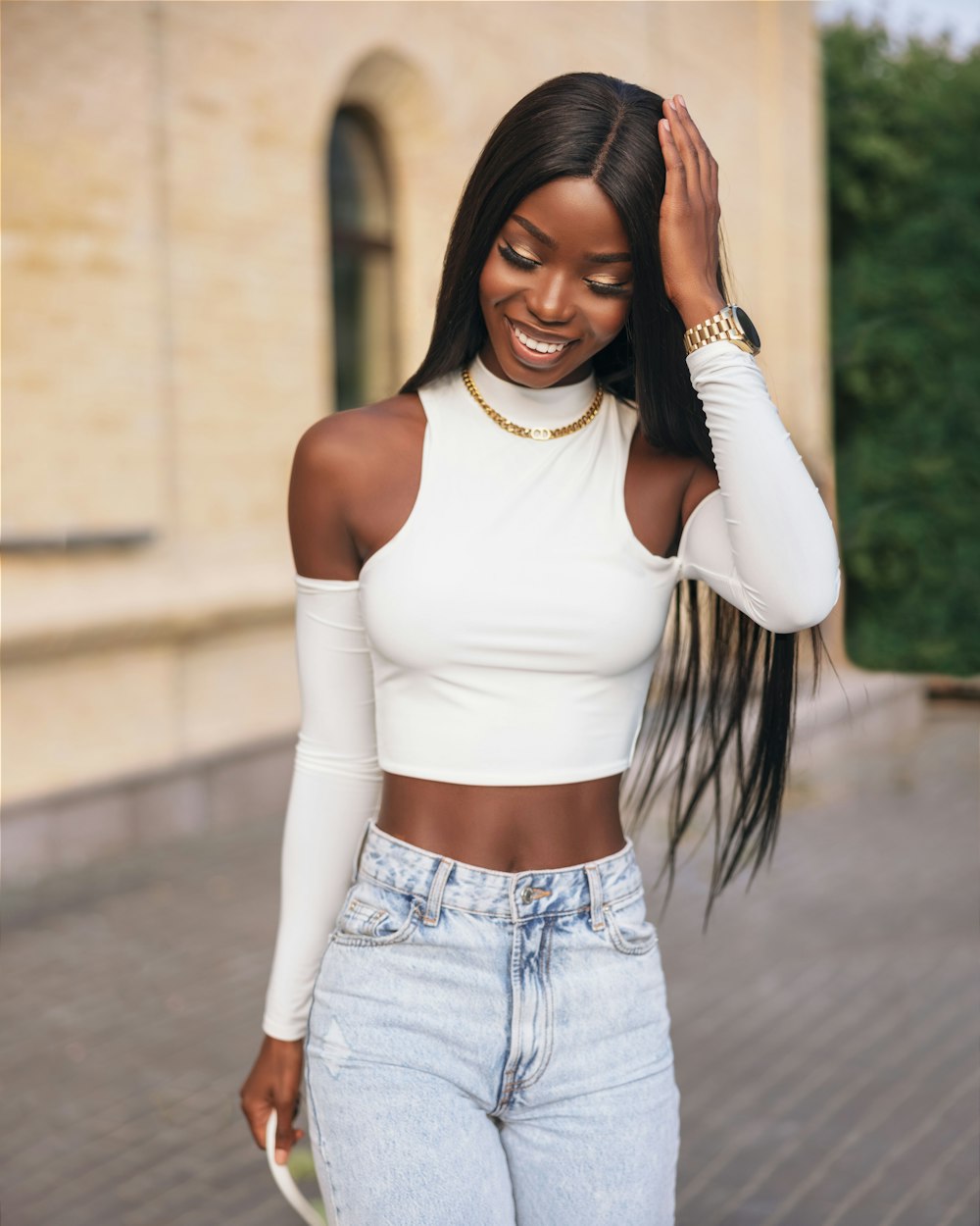 a woman with long hair wearing a white crop top