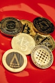 a pile of bitcoins sitting on top of a red table