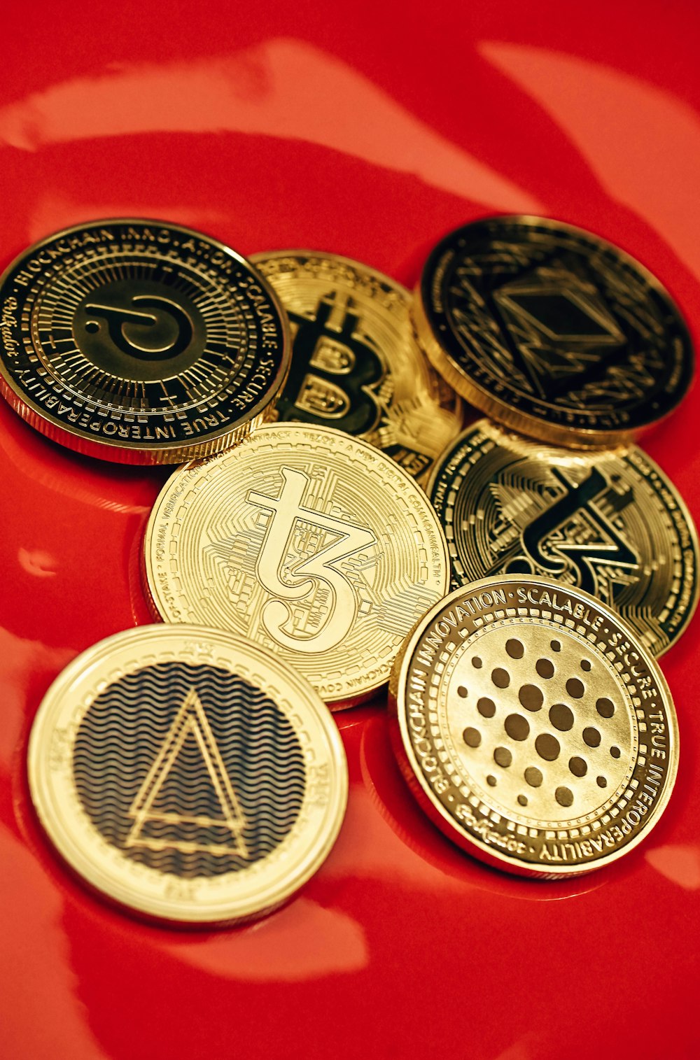 a pile of bitcoins sitting on top of a red table