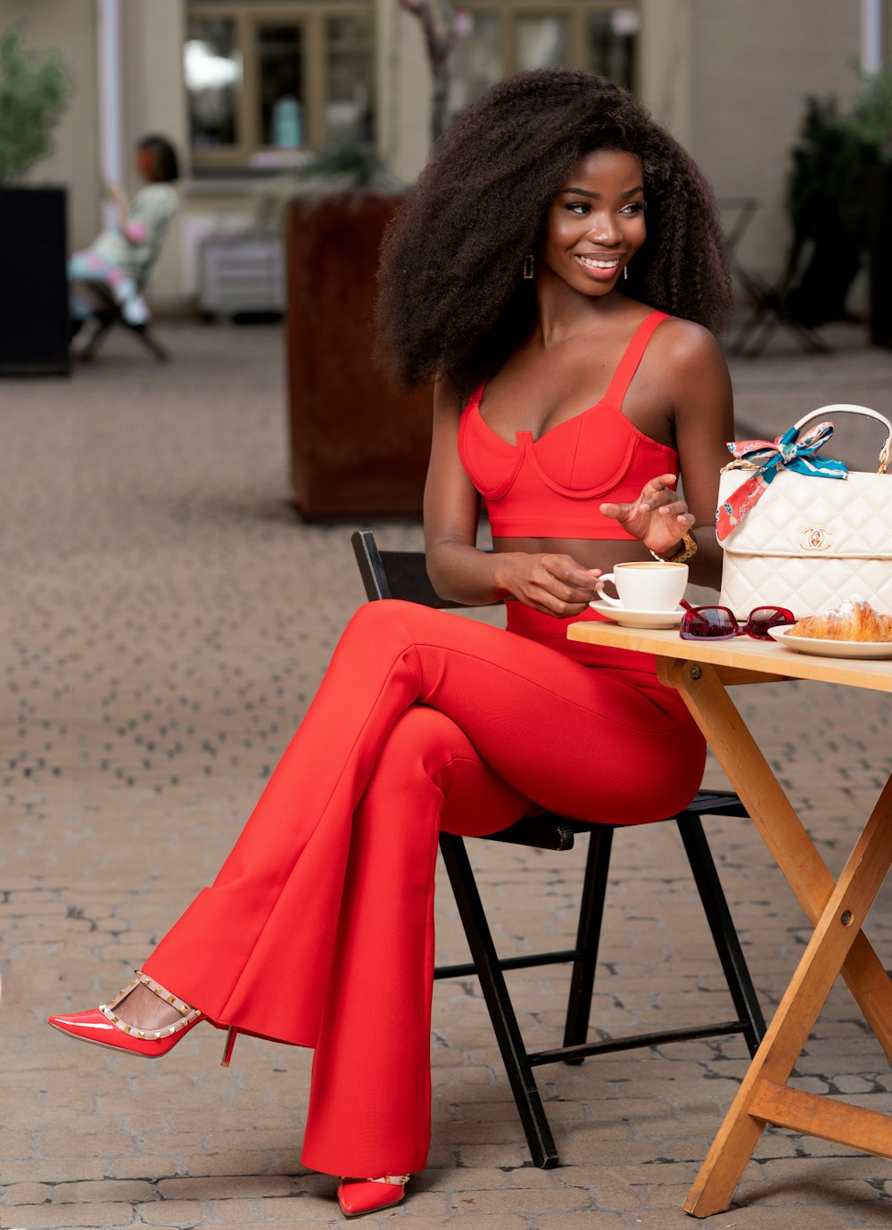 a woman sitting at a table with a cake