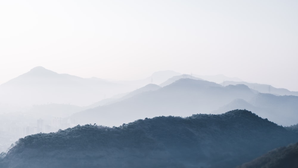 a view of a mountain range covered in fog