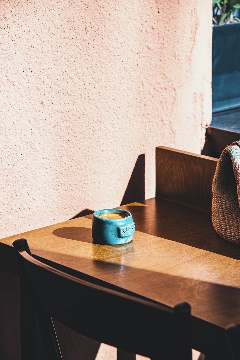 a wooden table with a blue bowl on top of it