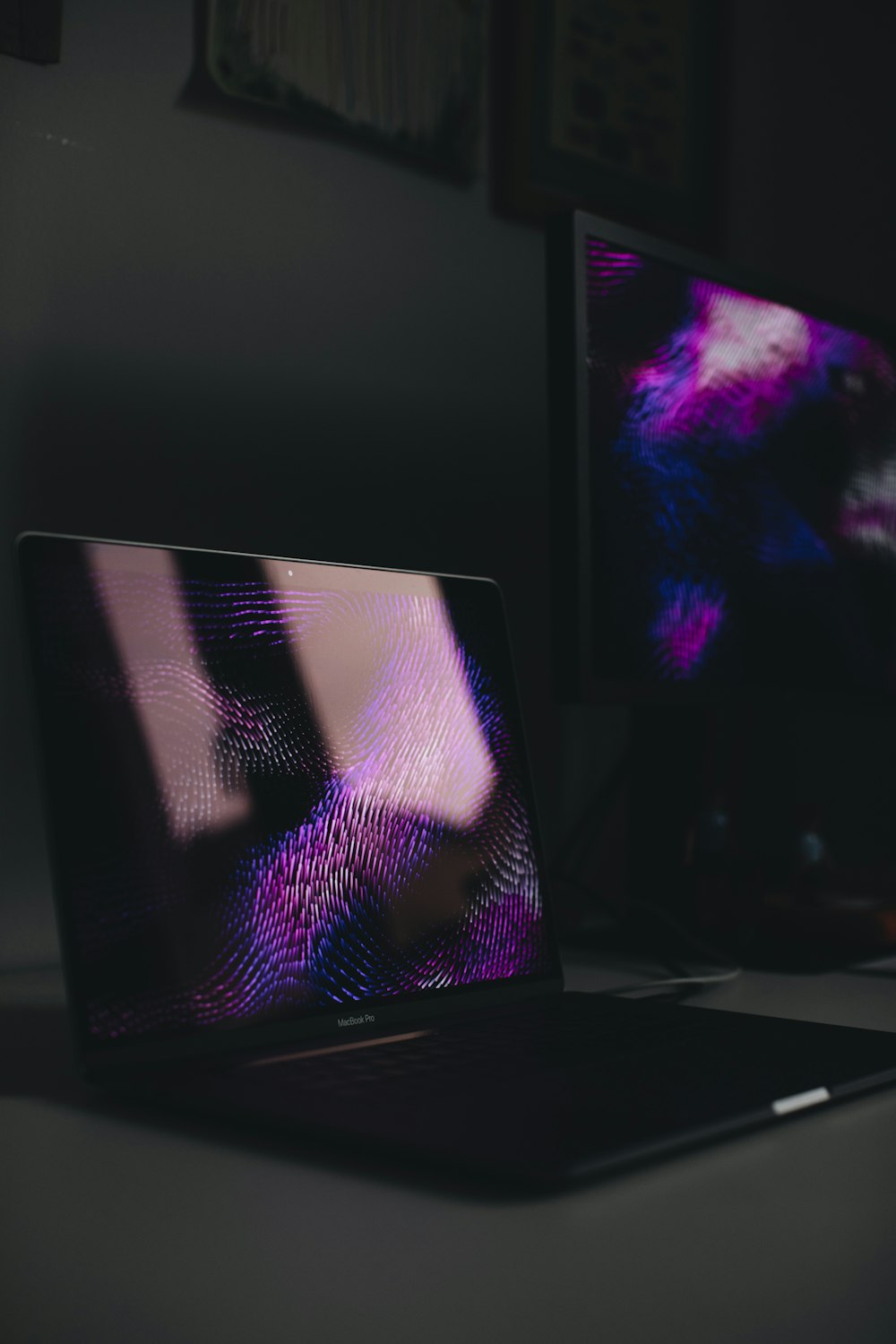 a laptop computer sitting on top of a desk