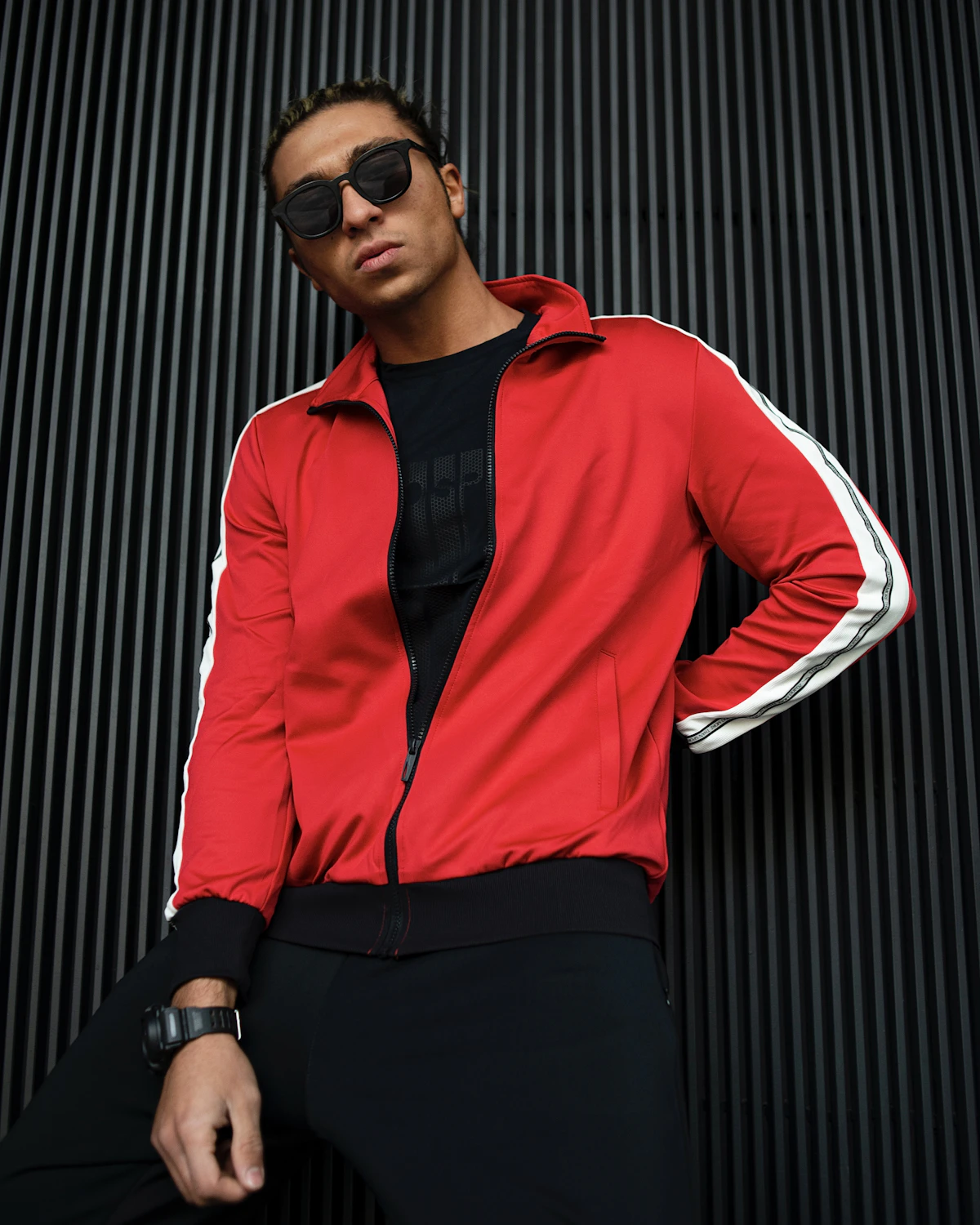Man in a red track jacket with white side stripes