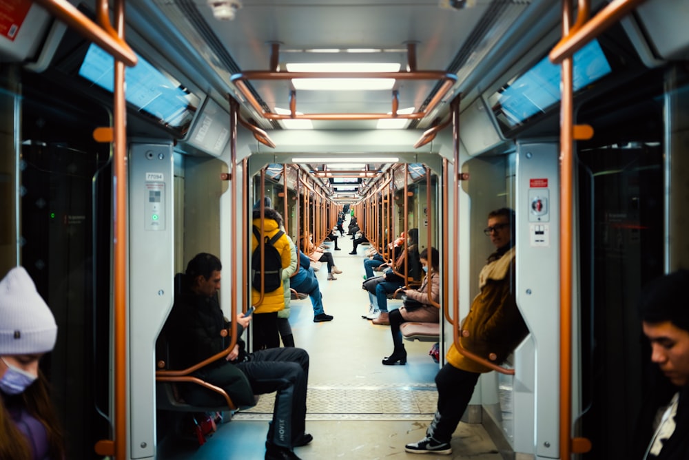 a group of people sitting on a subway train