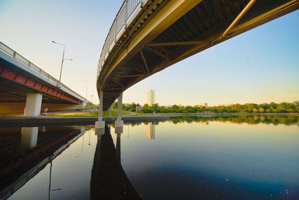 a bridge over a body of water next to a tall building