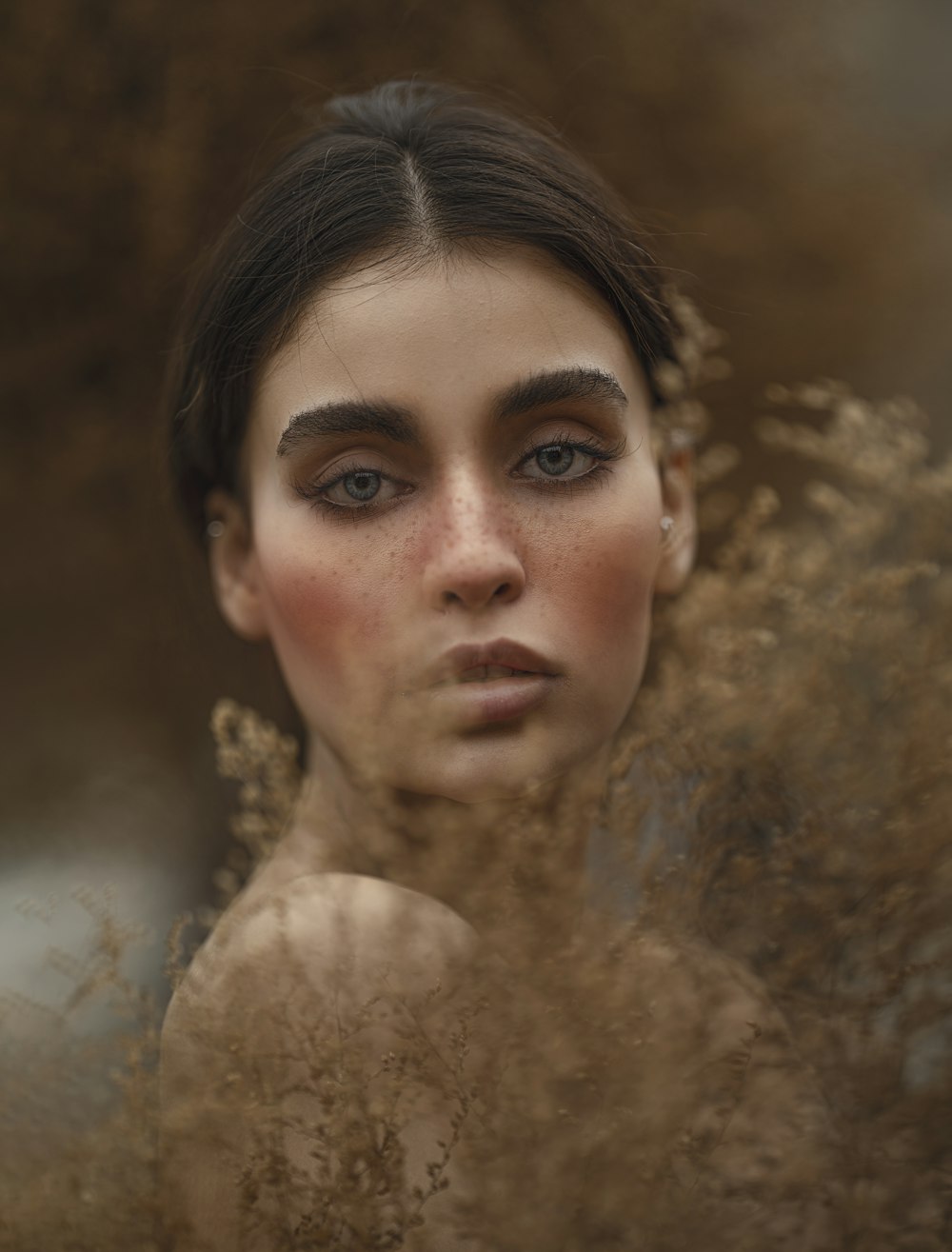 a woman with freckled hair and blue eyes