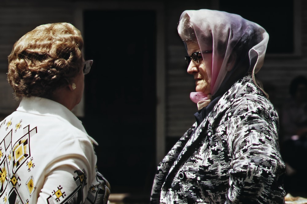 a woman in a headscarf talking to another woman