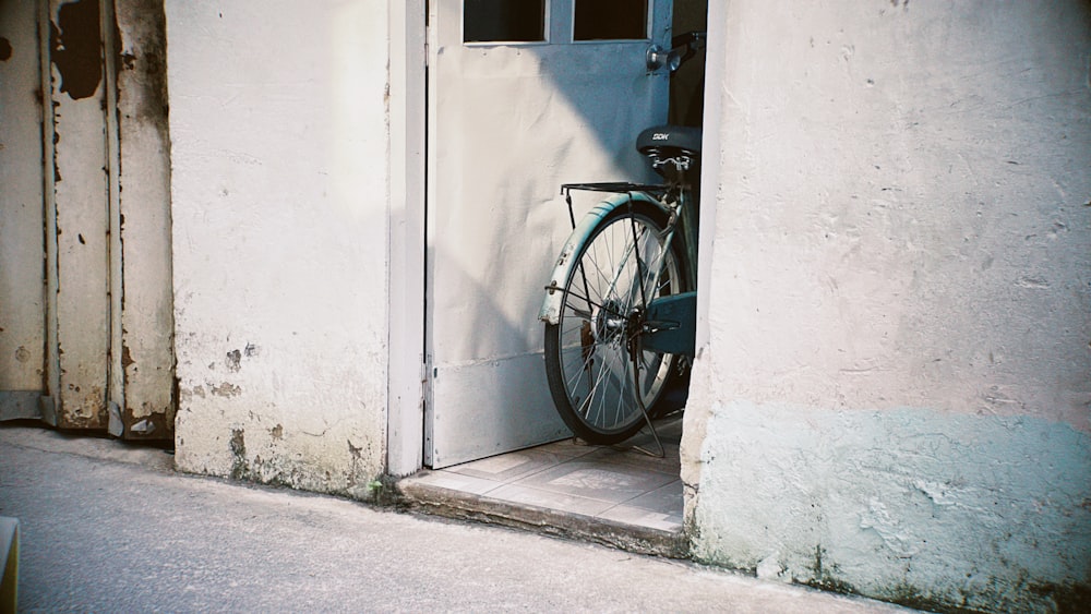a bicycle locked to a door in a building