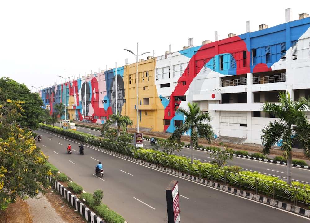 a city street with a mural on the side of a building