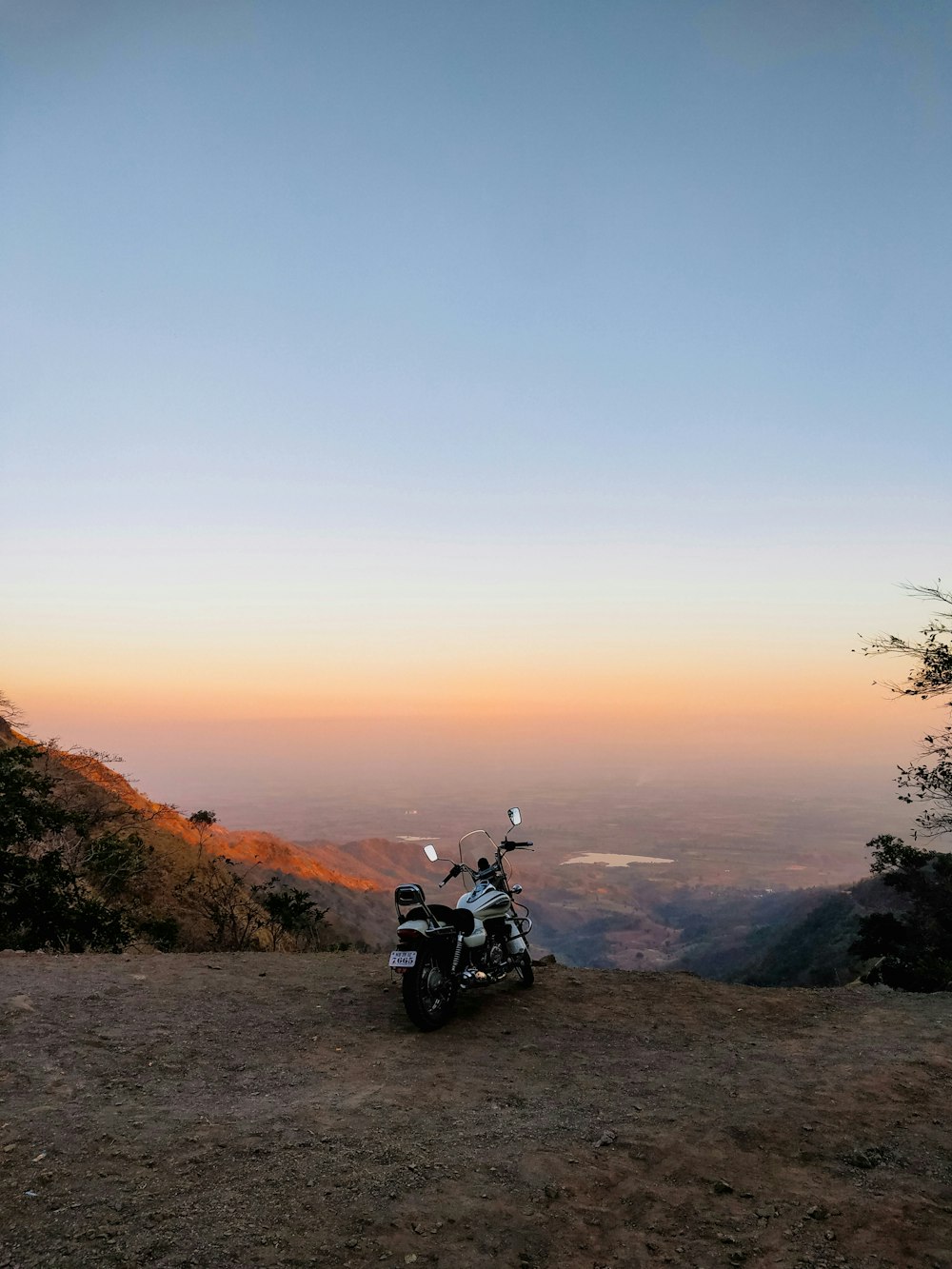 a motorcycle parked on top of a hill