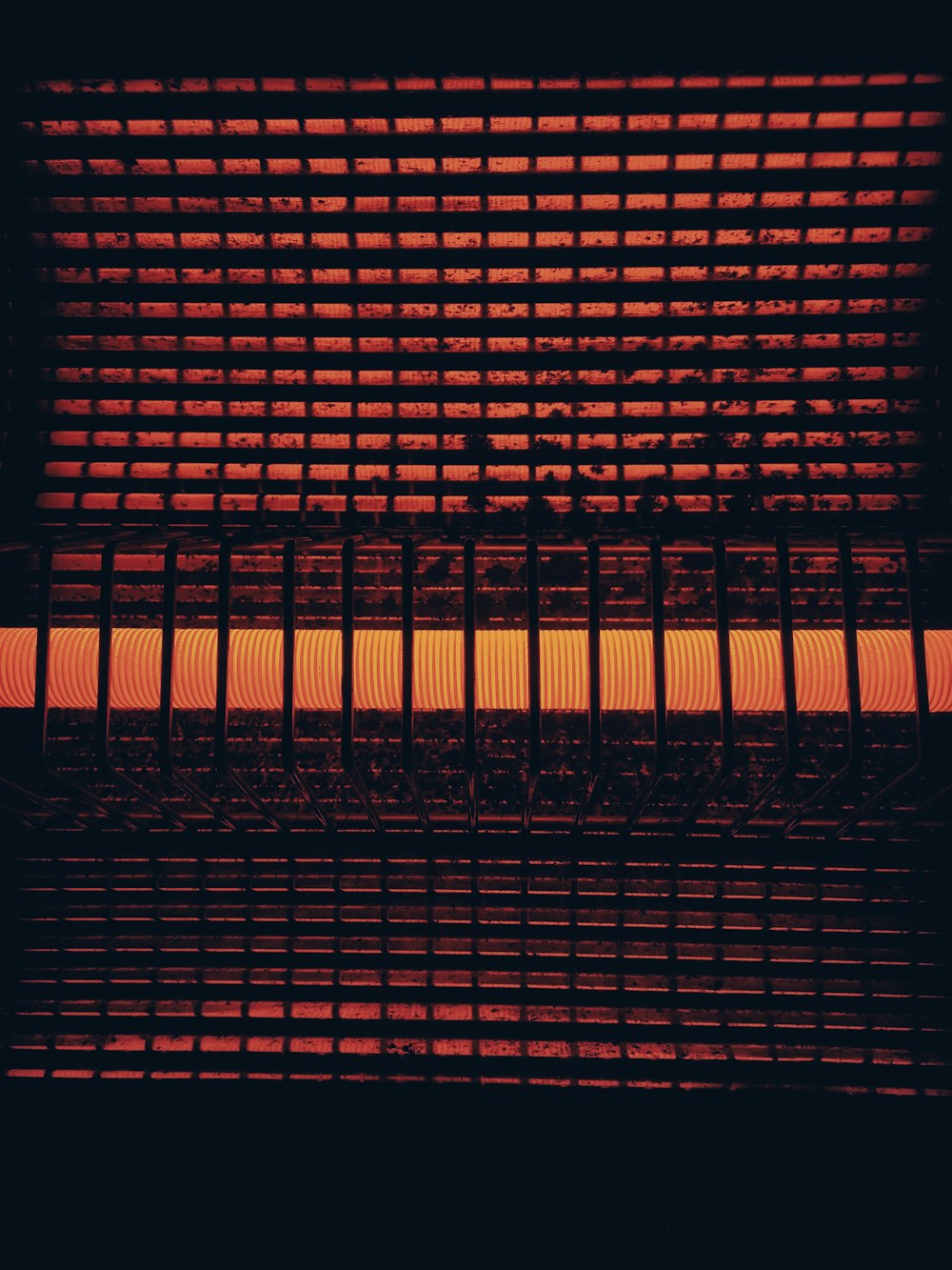 a close up of a heater that is red and orange