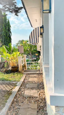 A caring staff member gently guiding a resident through a peaceful garden path.