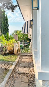 A peaceful garden path surrounded by blooming flowers where residents take leisurely walks.