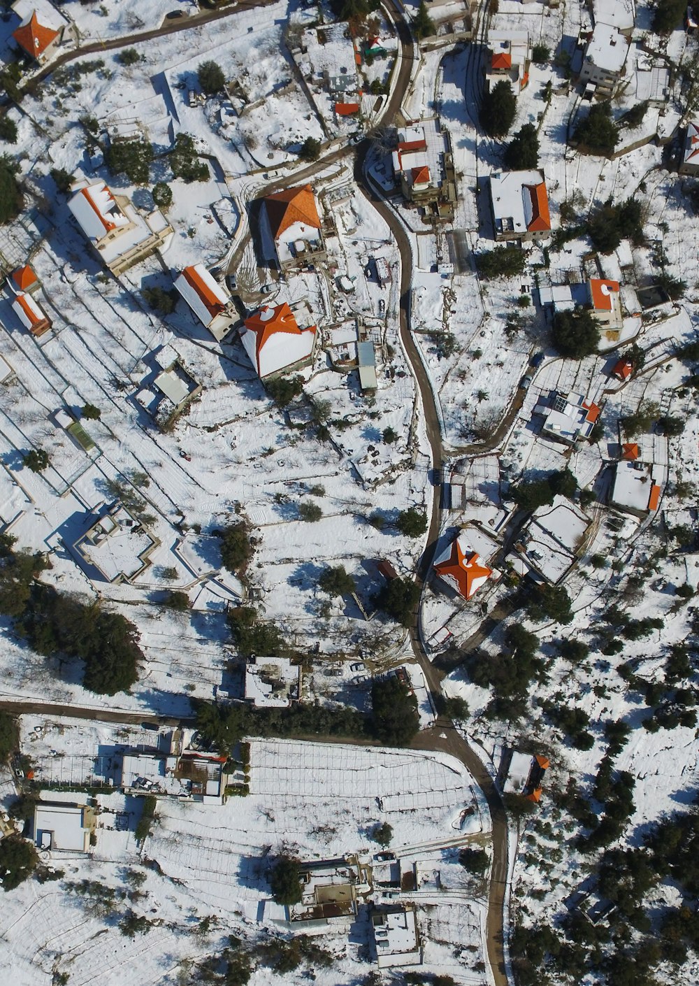 an aerial view of a snow covered town